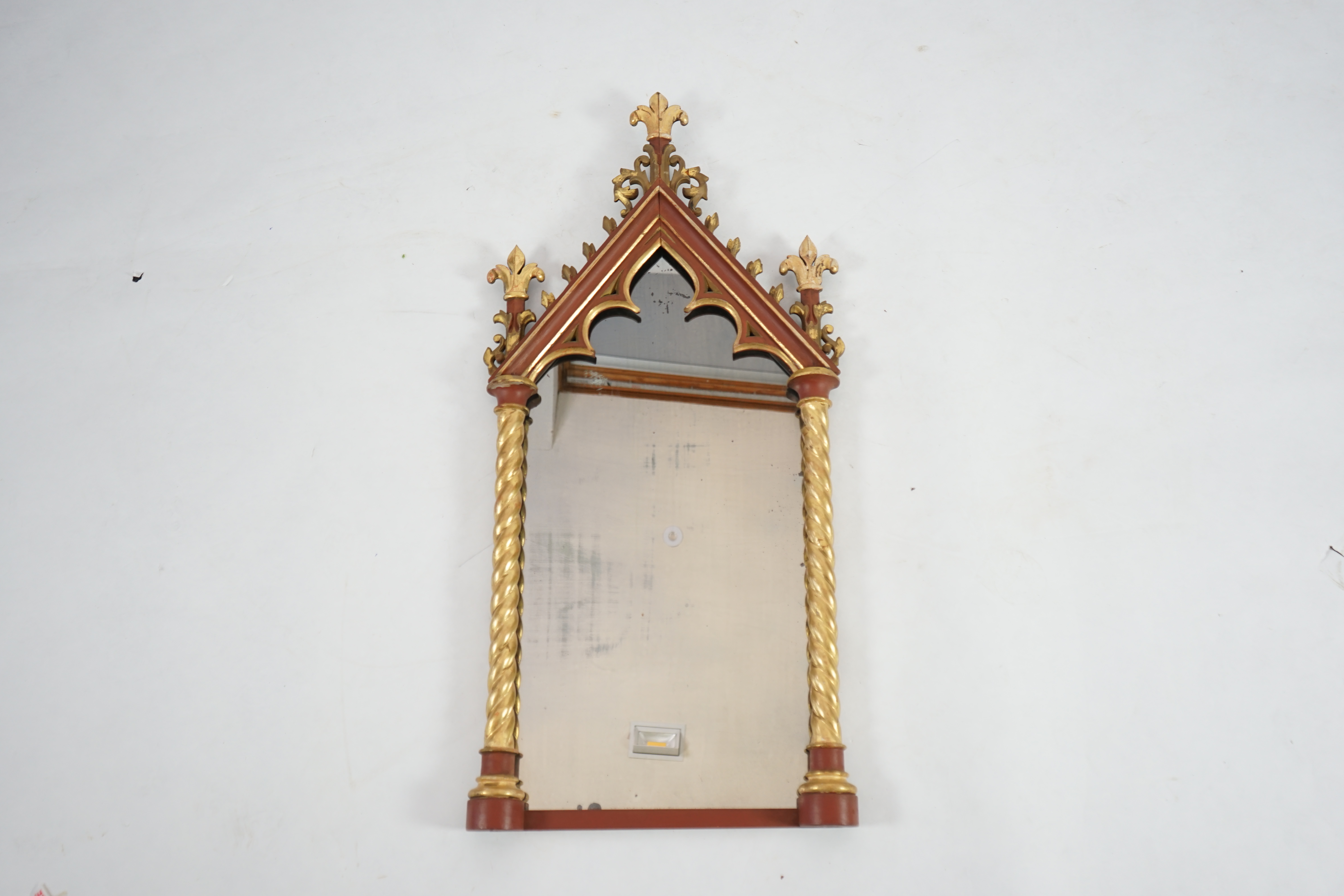 A Victorian Gothic revival painted and giltwood wall mirror